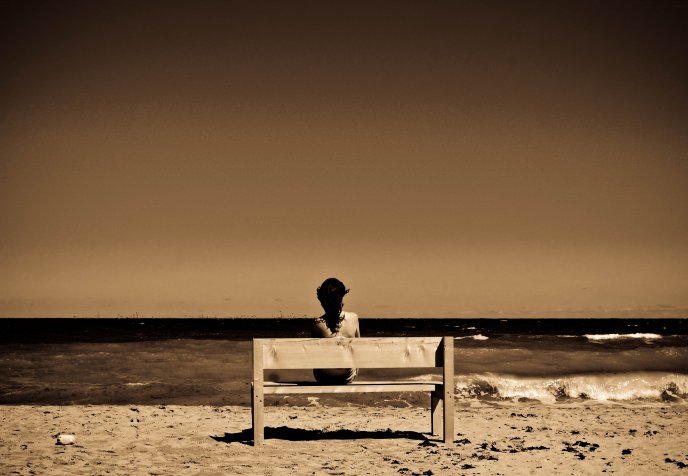 Alone on a bench at the seaside