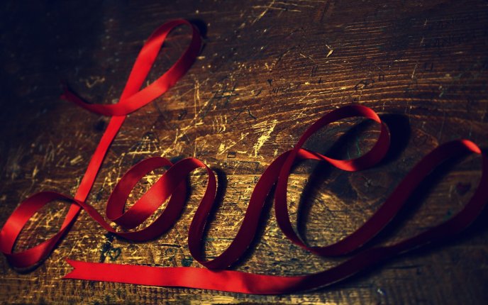 Love - written with a red ribbon