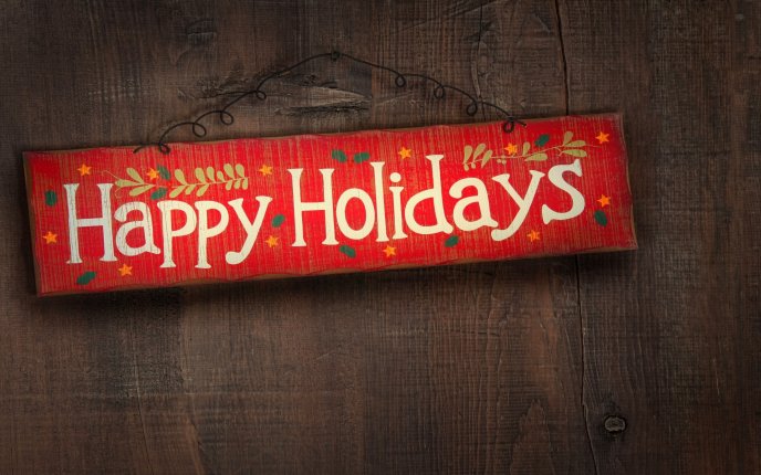 Happy Holidays written on a piece of wood