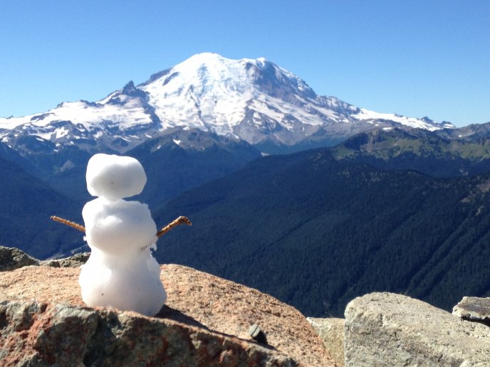 Little snowman on the top of the mountain
