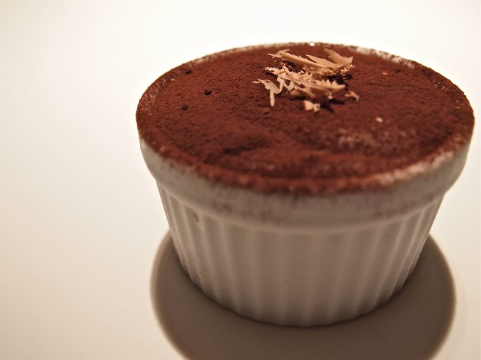 Chocolate in a cup dusted with cocoa
