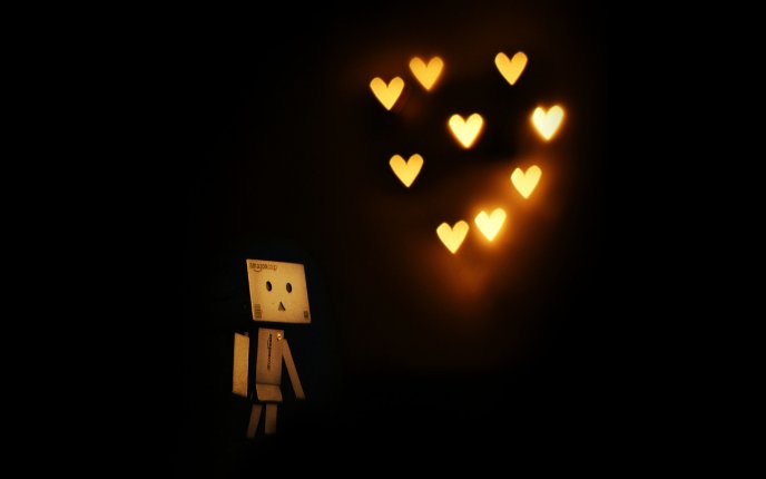 Cardboard robot is dreaming at hearts