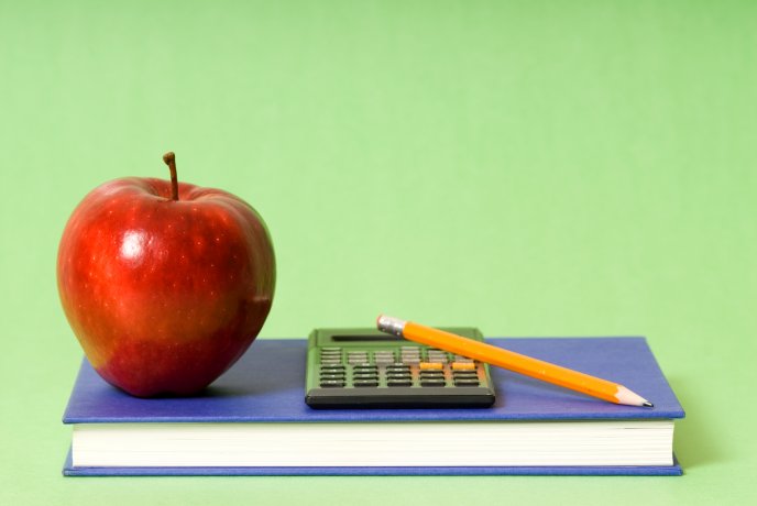 Book, apple, pencil and calculator - basic school stuff