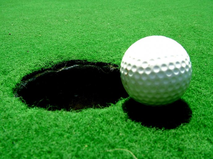Big hole and the white golf ball on the field - HD wallpaper