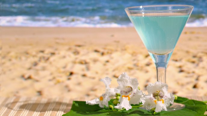 Blue fresh summer cocktail at the beach