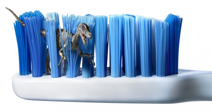 Funny wallpaper - little dinosaur playing with toothbrush