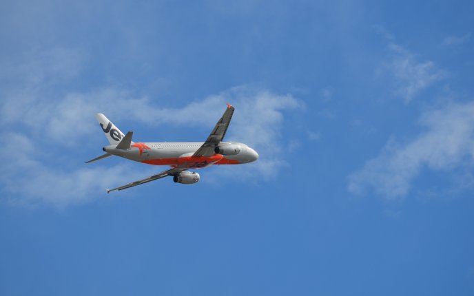 An Airbus A320 airplane flying on the blue sky