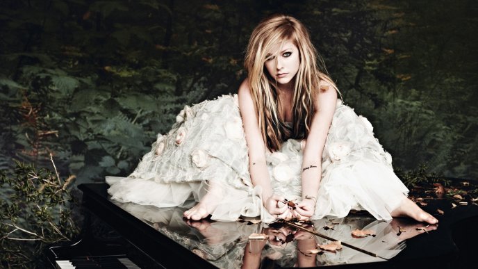 Avril Lavigne in white dress on the piano