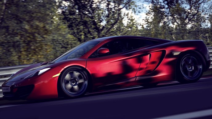 Red McLaren in speed on the road