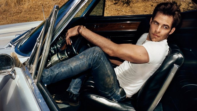 Chris Pine in a convertible car with opened door