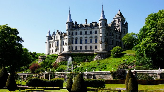 Dunrobin Castle on hill  and a green garden