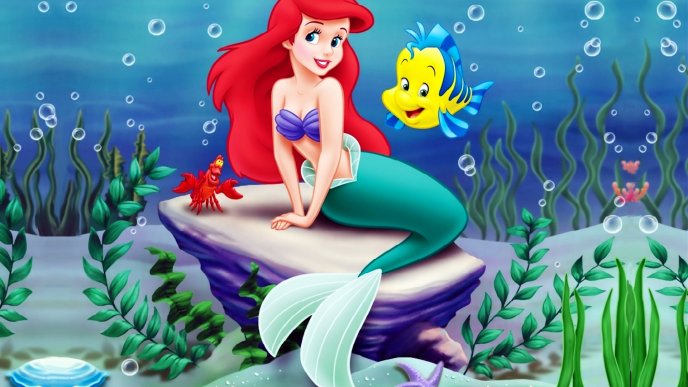 The Little Mermaid on a stone with two fish