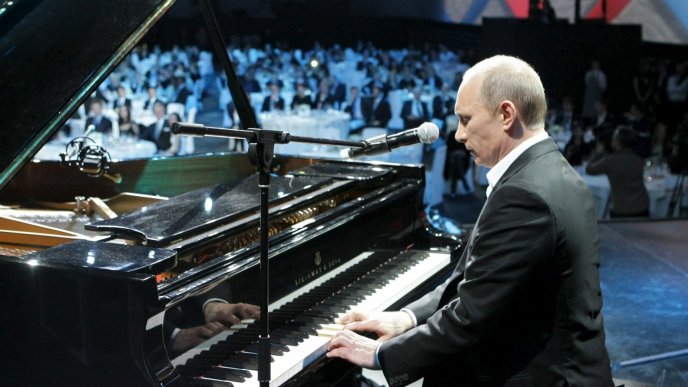 Vladimir Putin playing piano in a concert