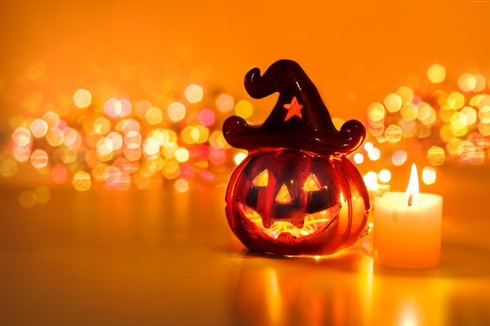 Funny pumpkin and candle in fire - Halloween Party