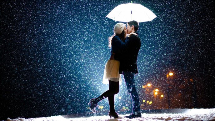 Sweet kiss under the umbrella - Wonderful snowing night