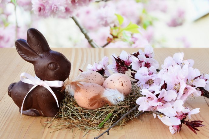 Chocolate Easter bunny and a nest with eggs - Happy Holiday