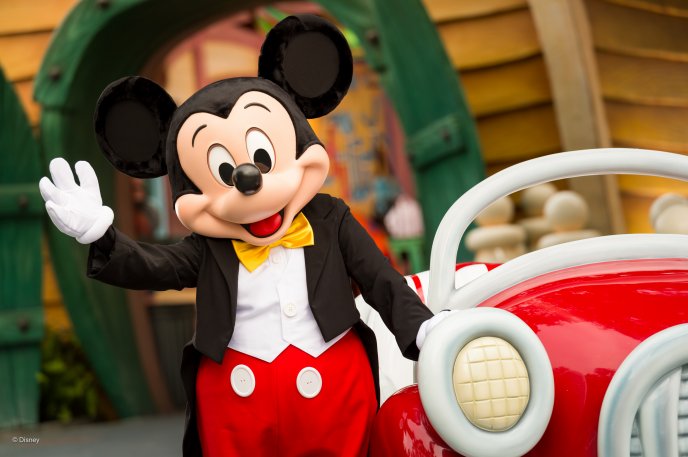Happy Mickey Mouse near a red car - Happy childhood time