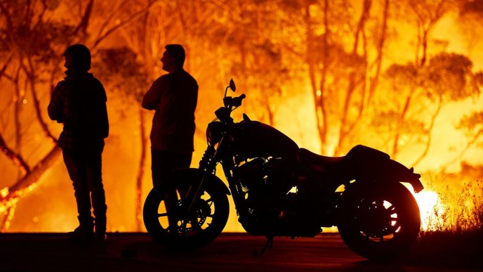 Two people and a motorcycle in Australia - Fire on continent