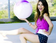 Victoria Justice holding a big white balloon