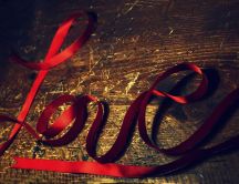 Love - written with a red ribbon