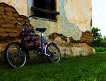 Bike leaning against an old house of clay