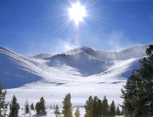 Sunlight warms the snowy mountains of Russia