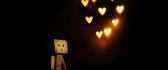 Cardboard robot is dreaming at hearts