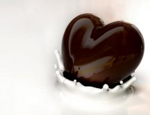 Delicious heart chocolate in cream milk