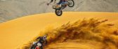 Motorcycle jumping contest on sand dunes