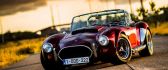 Old classic car - small AC Cobra on the road