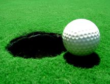Big hole and the white golf ball on the field - HD wallpaper