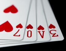 Poker cards - love message and red hearts
