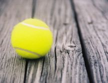 Tennis ball on the old wood