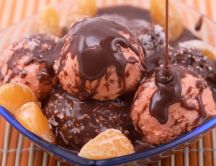 Delicious ice cream with chocolate topping and oranges