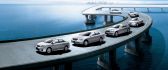 Parade of Toyota cars on the bridge over the ocean