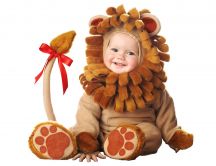 Sweet baby dressed in a bear suit with red knot on the tail