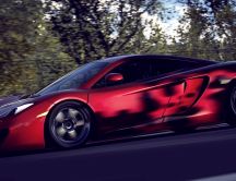 Red McLaren in speed on the road