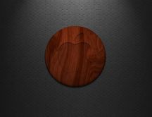 Red apple logo on a circle made of wood
