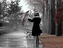 Walking in the park with an umbrella in a rainy day