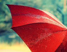 Beautiful red umbrella full with water drops