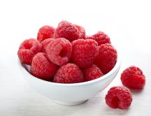 Cup full with delicious raspberries - summer vitamins