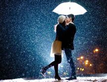 Sweet kiss under the umbrella - Wonderful snowing night