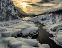 Warm sunset over the cold mountain river - Winter season
