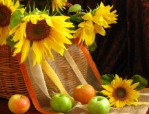 Sunflowers in a bascket and delicious summer apples