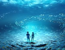 Anime boy and girl in the middle of the ocean with fishes