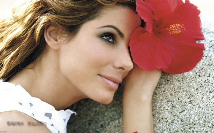 Sandra Bullock with a beautiful red flower