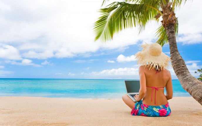 Girl on the beach with her laptop