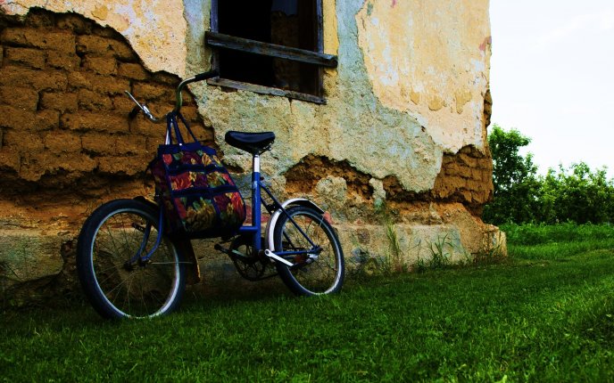 Bike leaning against an old house of clay