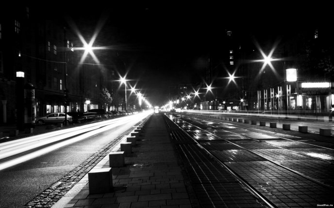 Street and sidewalk illuminated at night