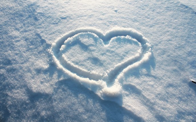 Heart shape in white and fluffy snow HD wallpaper